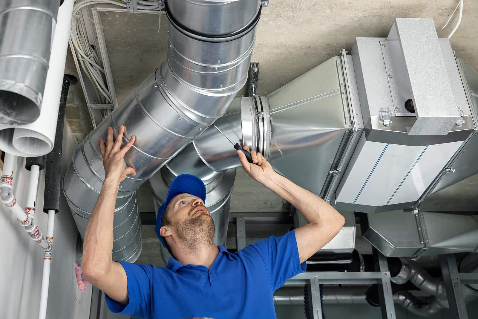 HVAC technician inspecting and repairing air ducts in Vacaville