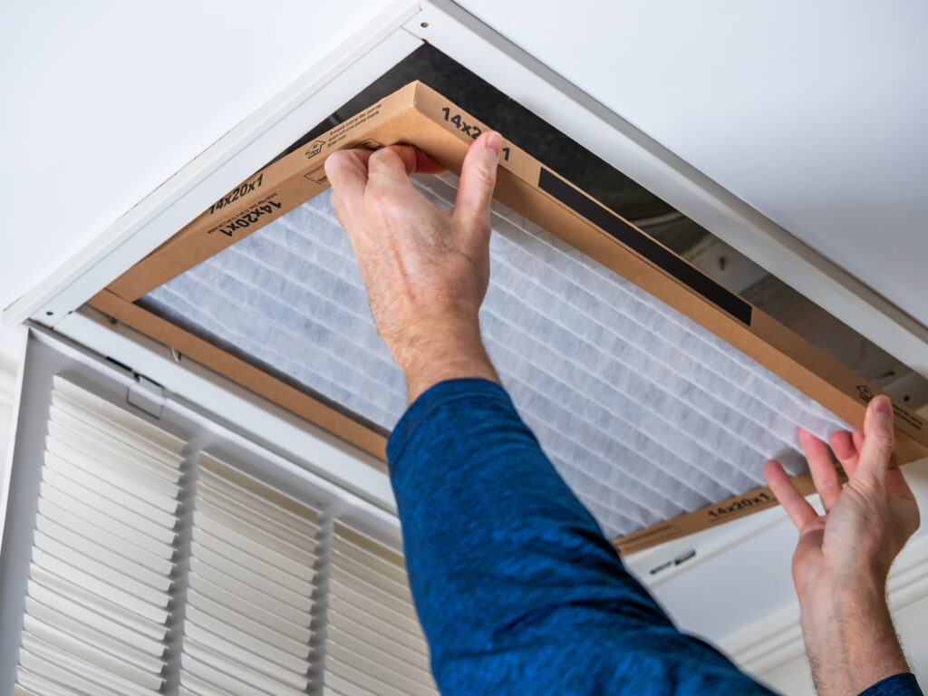 HVAC technician replacing a home air filter in Vacaville