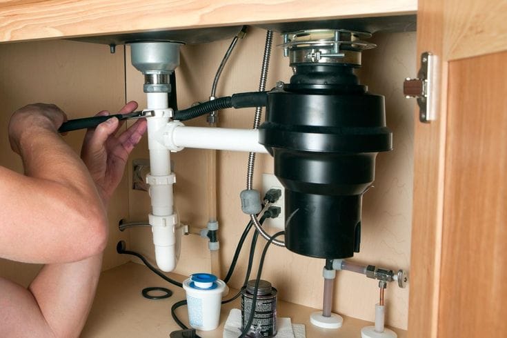 Plumber repairing a garbage disposal in Vacaville