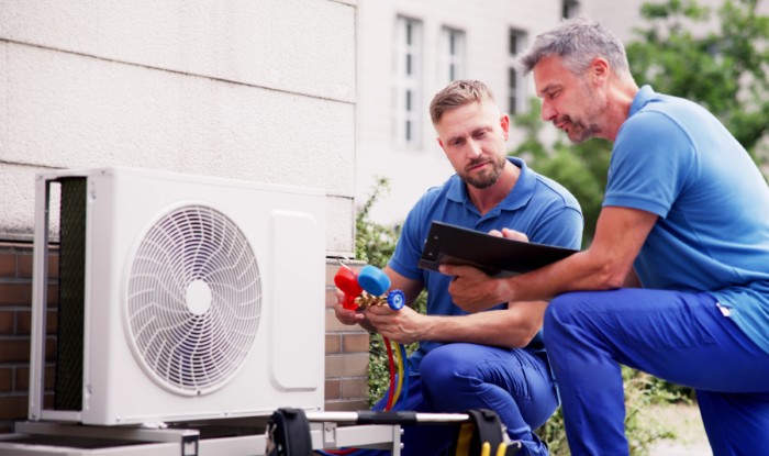 HVAC technicians installing an outdoor air conditioning unit in Vacaville