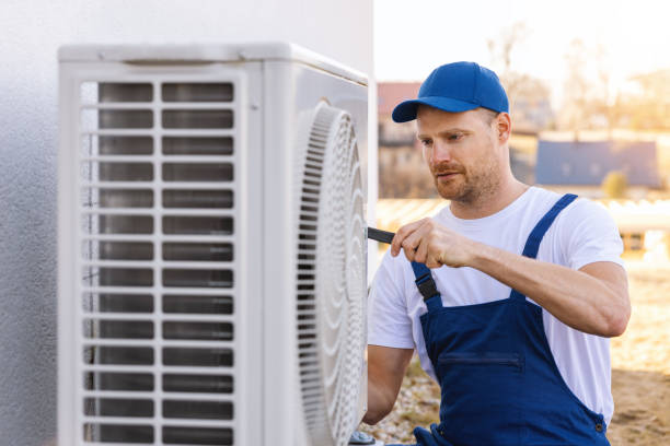 HVAC technician servicing an outdoor air conditioner in Vacaville