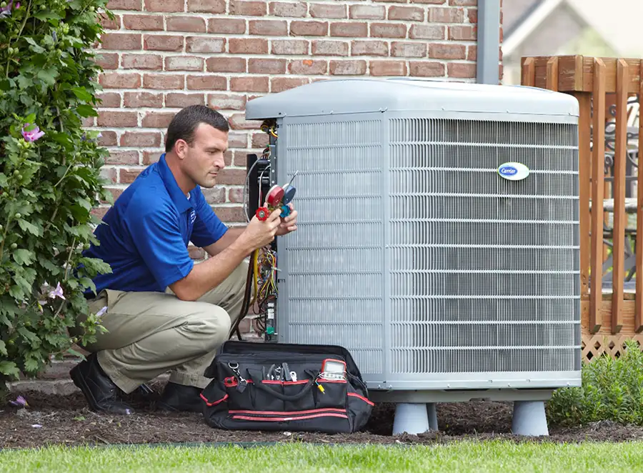 HVAC technician inspecting an outdoor AC unit in Vacaville